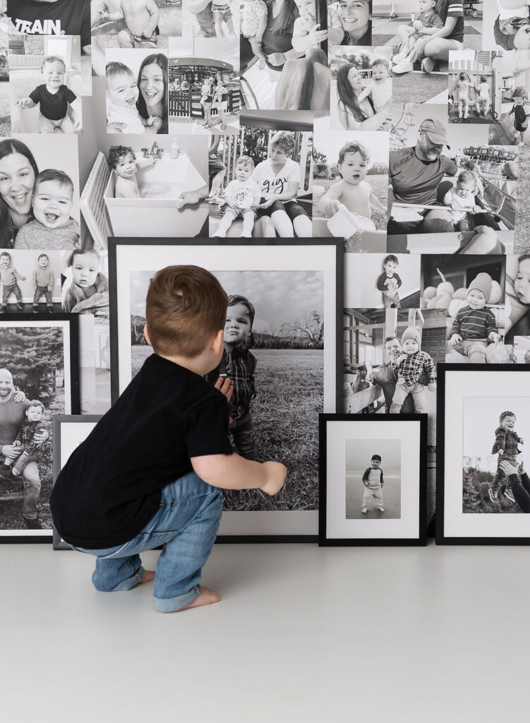 boy lookin at his image on custom photo backdrop