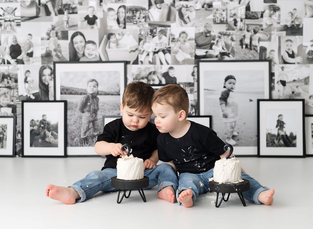 twin looking at brother's cake