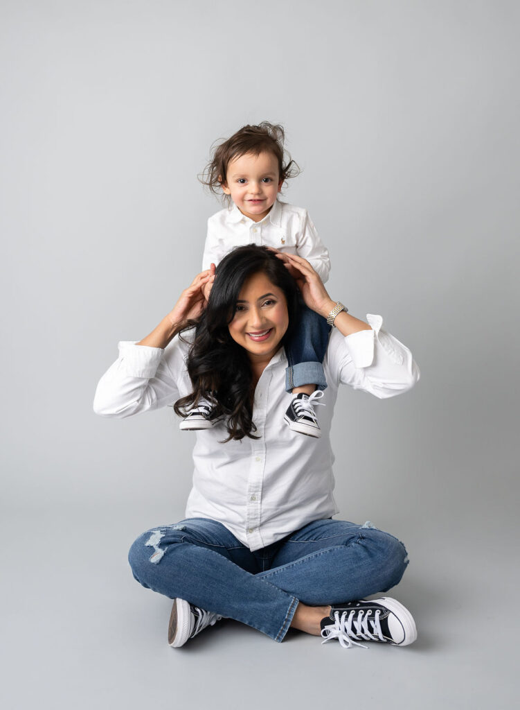 piggy back rides with son and mom during motherhood photo session