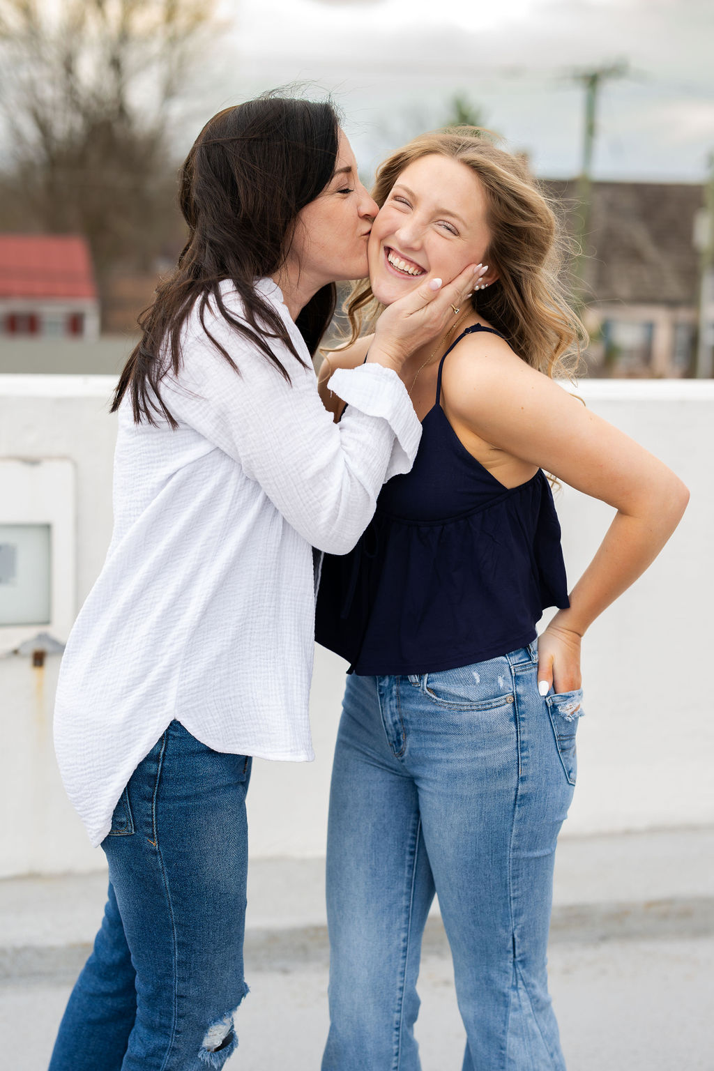 Mother kissing daughter during Senior photoshoot